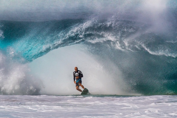 A surfer riding a powerful wave at Banzai Pipeline