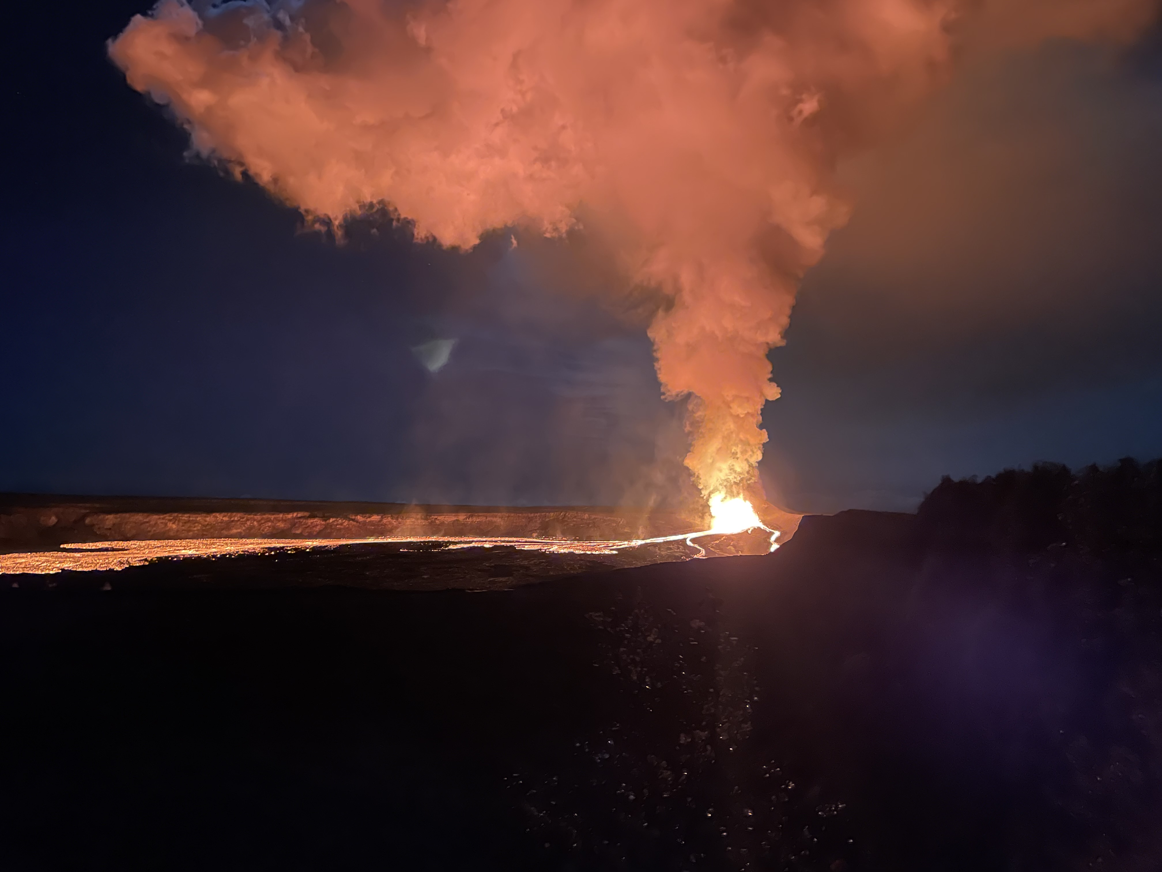 Nighttime lava fountains and a glowing gas plume rising from a Kīlauea vent