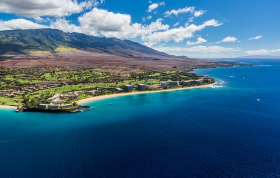 Aerial view of the Kāʻanapali resort coast below the West Maui Mountains