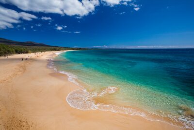 The wide white-sand expanse of Big Beach at Mākena, with turquoise surf