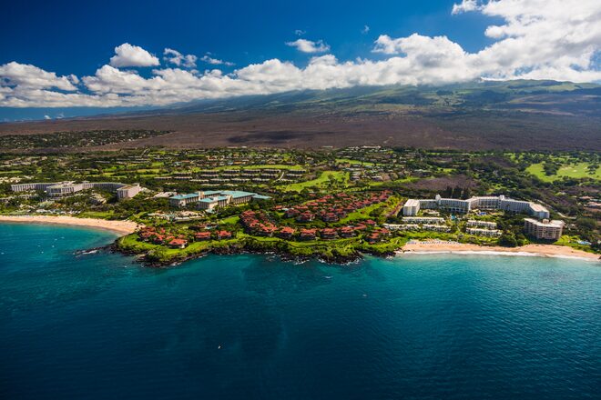 Aerial view of the Wailea coastline, its resorts and golf greens along the sea