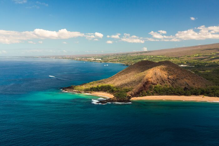 Aerial view of the Wailea and Mākena coast with the cinder cone Puʻu Ōlaʻi above turquoise water