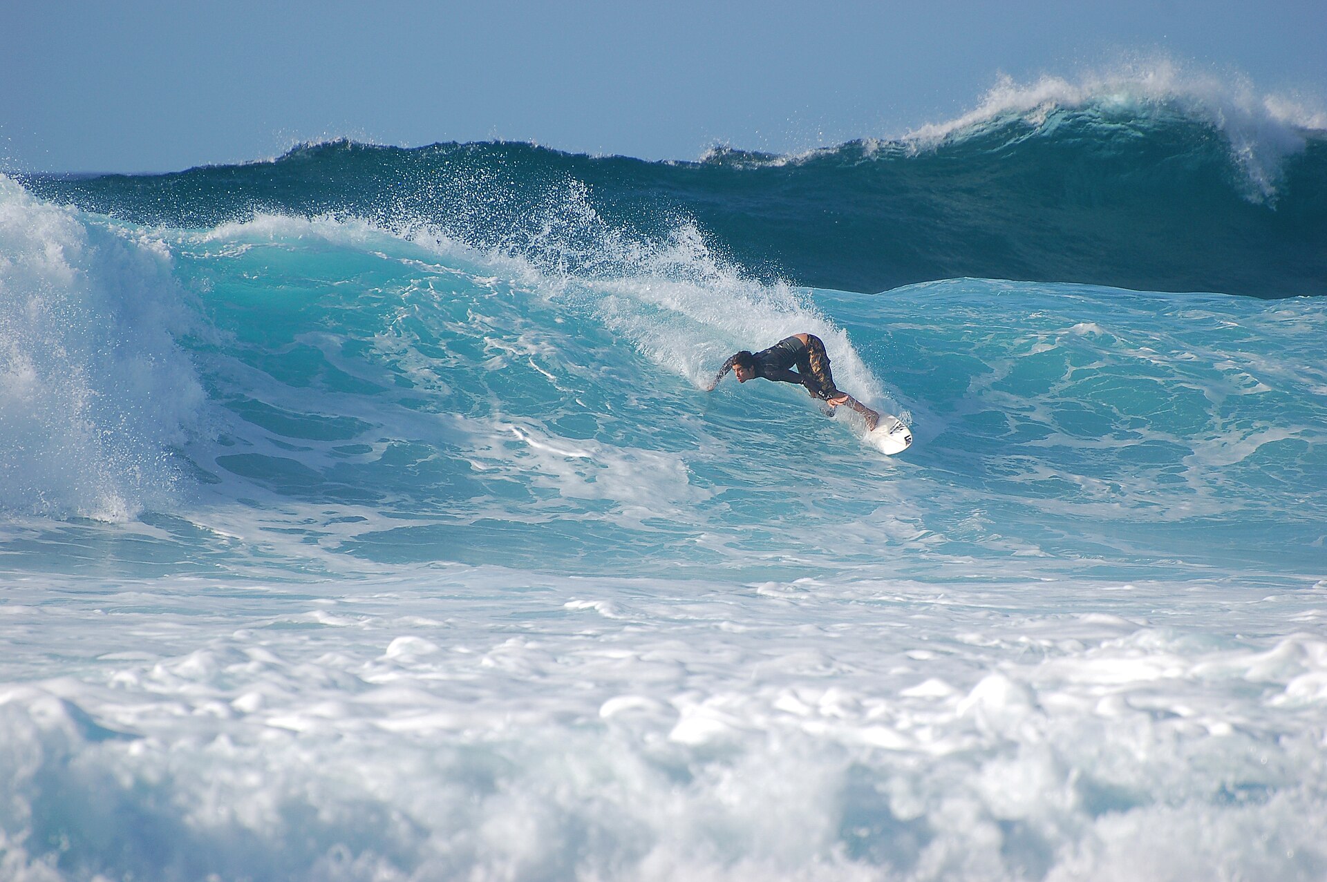 Surfer inside a curling wave at Banzai Pipeline